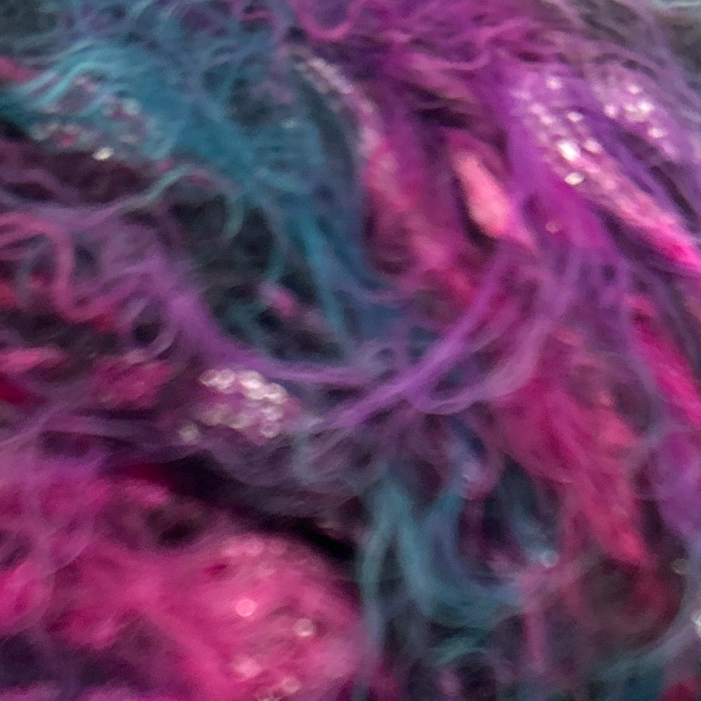 Multicolored yarn ball with a label on a white background