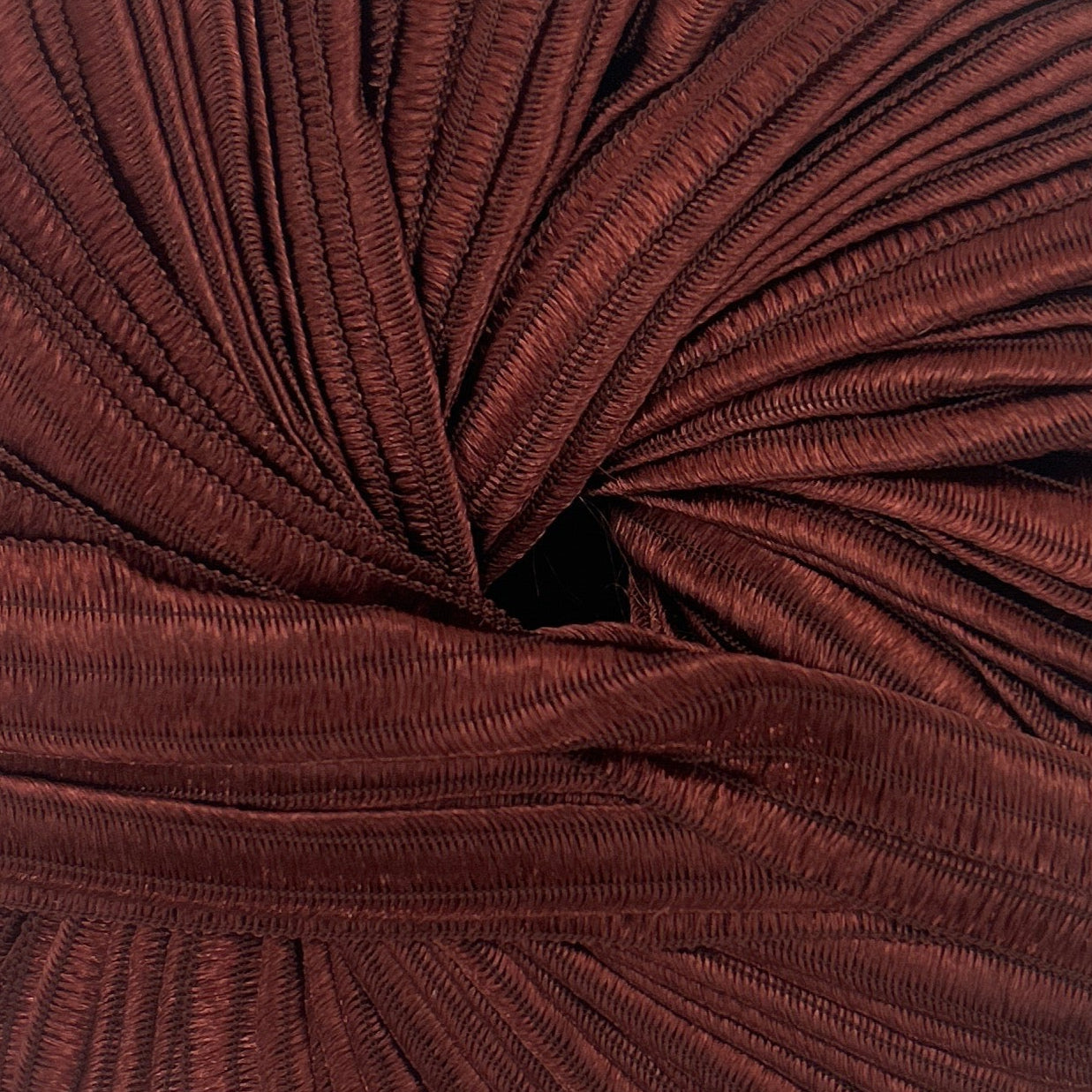 Brown knitted yarn ball on a white background