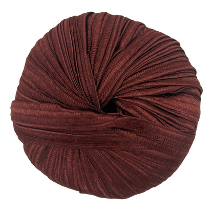 Ball of brown yarn on a light gray background