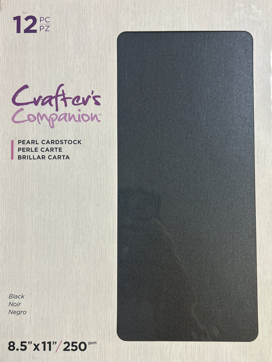 Package of black cardstock on a wooden surface
