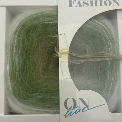 Green yarn skein in a clear plastic packaging with visible brand name on a white background