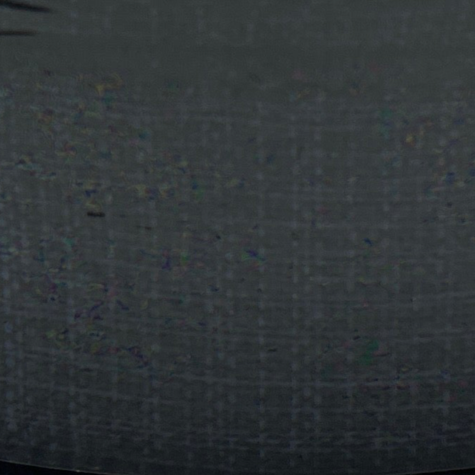 Dark gray fabric texture with small colorful specks