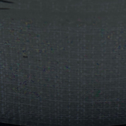Dark gray fabric texture with small colorful specks