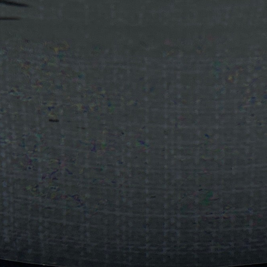 Dark gray fabric texture with small colorful specks