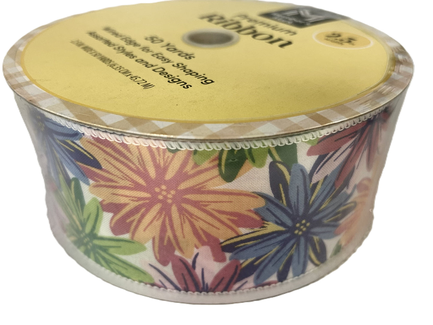 Spool of floral ribbon with a yellow label on a white background