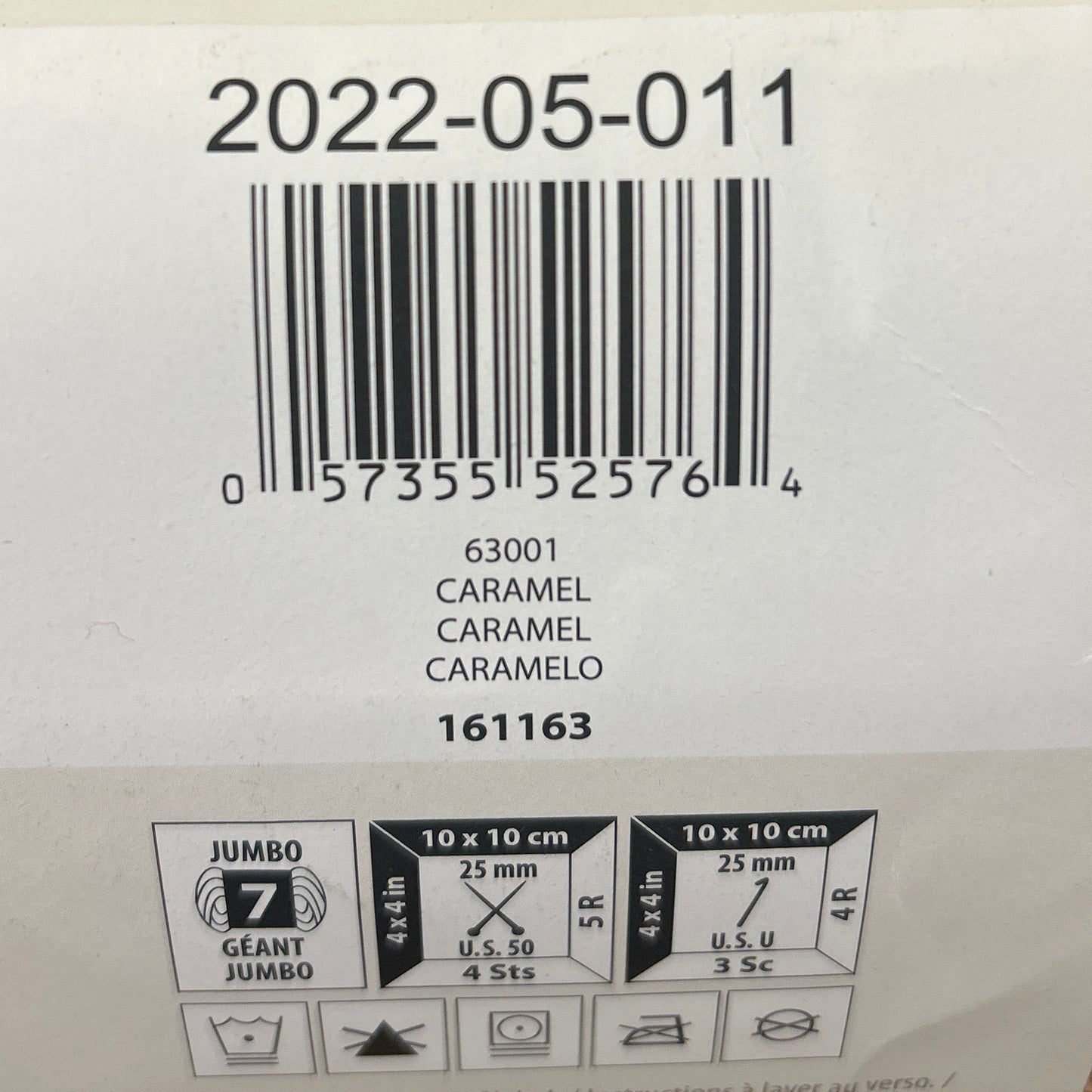 Close-up of a label on a yarn with barcode and text.