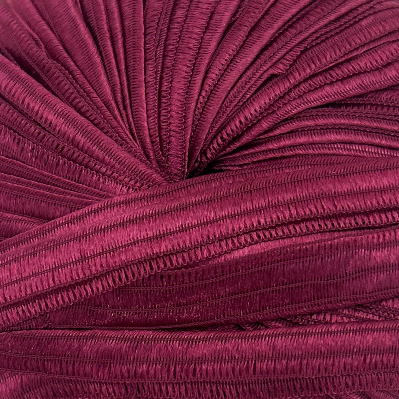 Purple knitted fabric roll on a white background