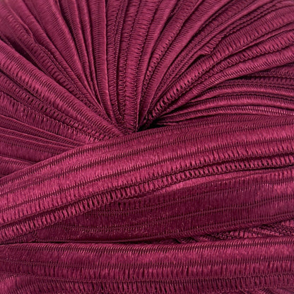 Purple knitted fabric roll on a white background