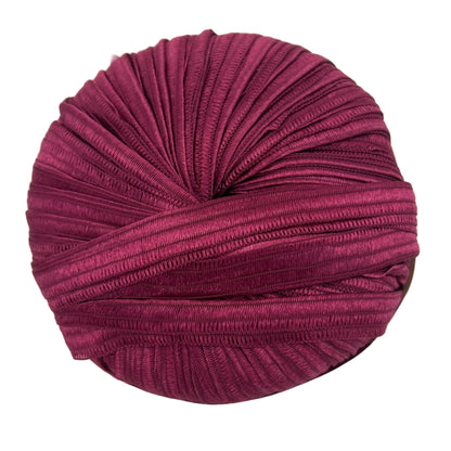 Purple knitted fabric roll on a white background