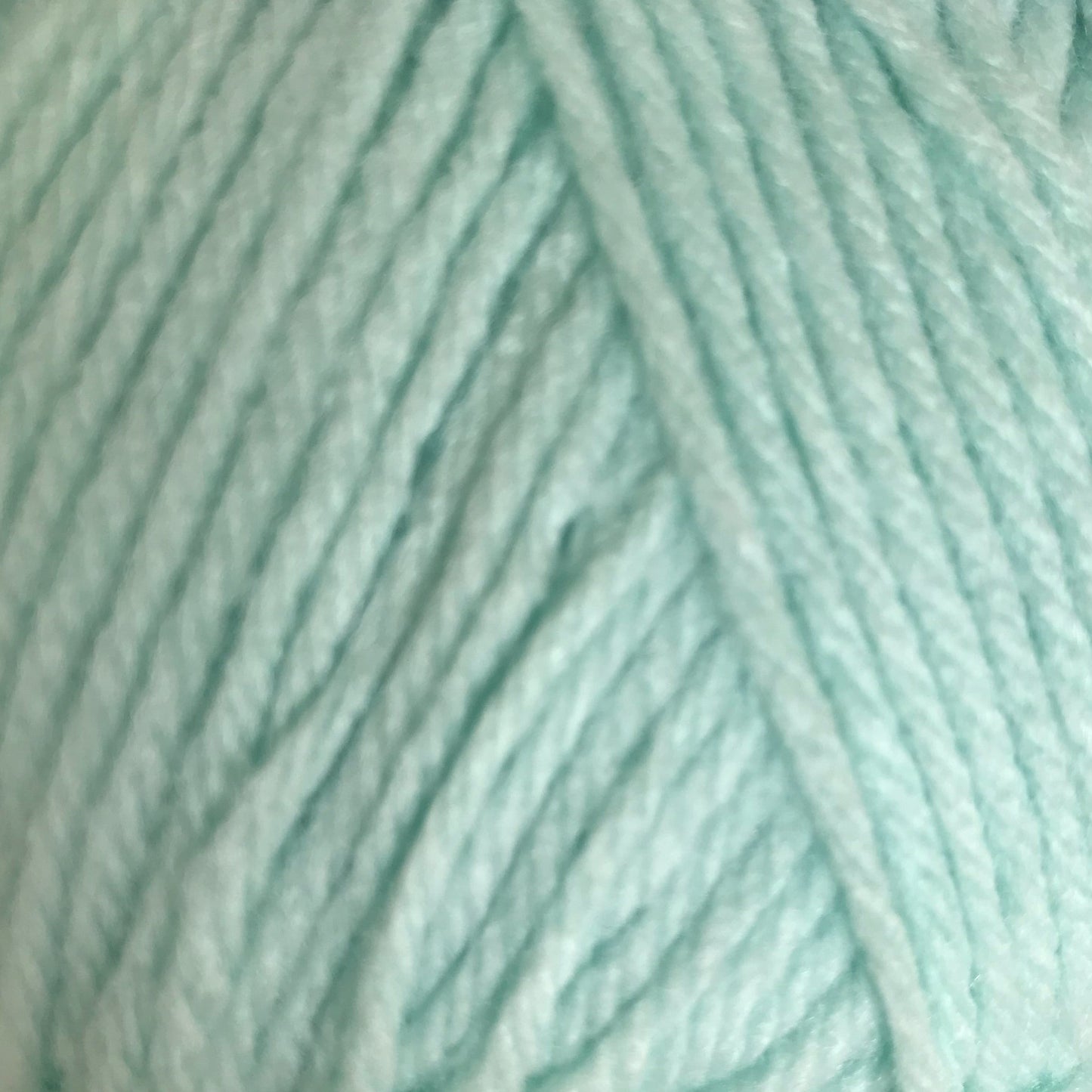 Close-up of light blue yarn with a subtle pattern