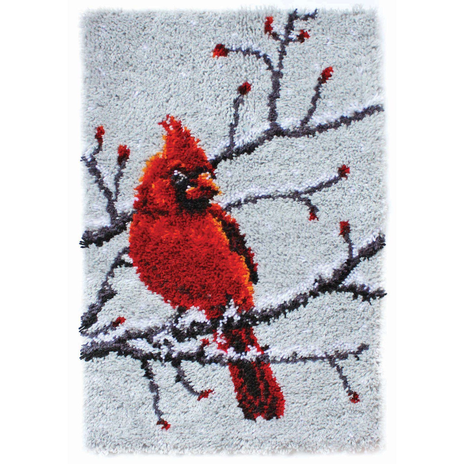 Cardinal bird on a branch with red berries on a textured gray background