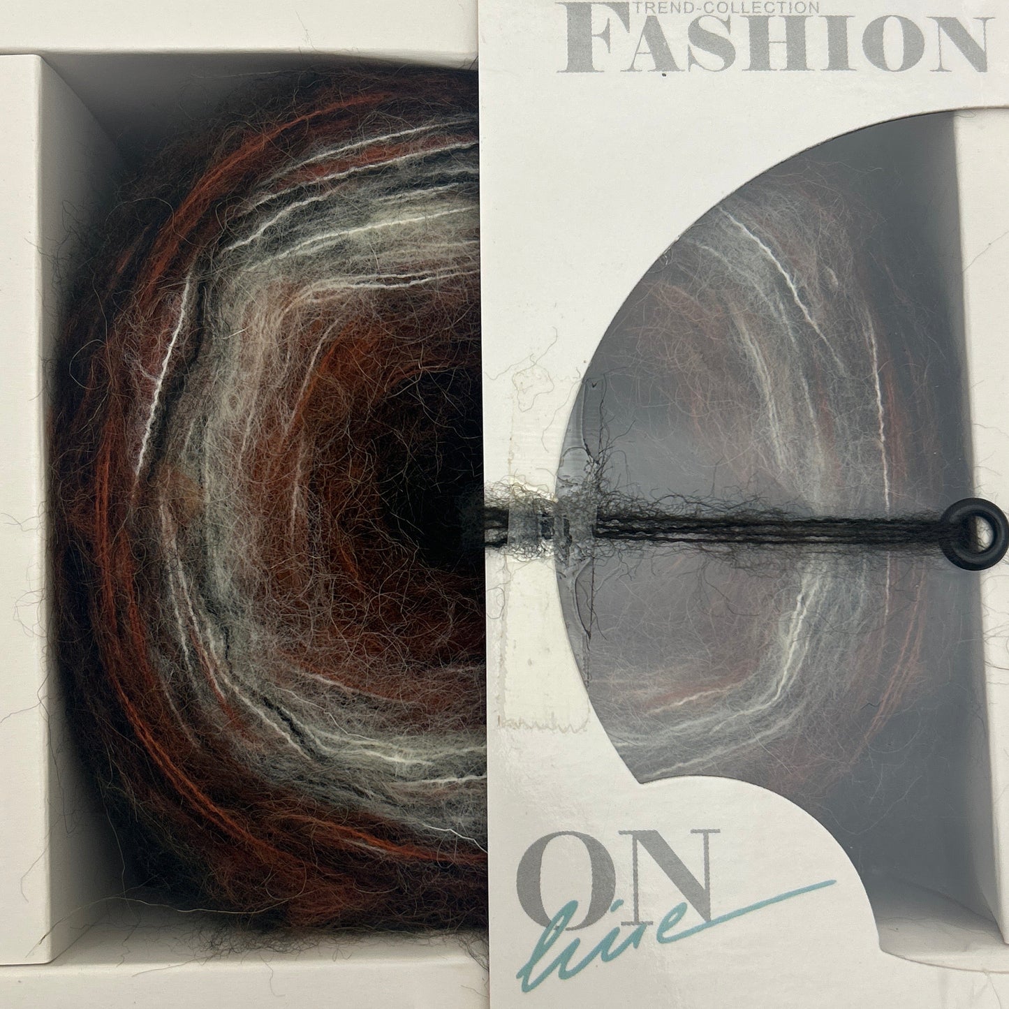 Yarn skein in a 'Fashion Box' packaging with a visible brand name.