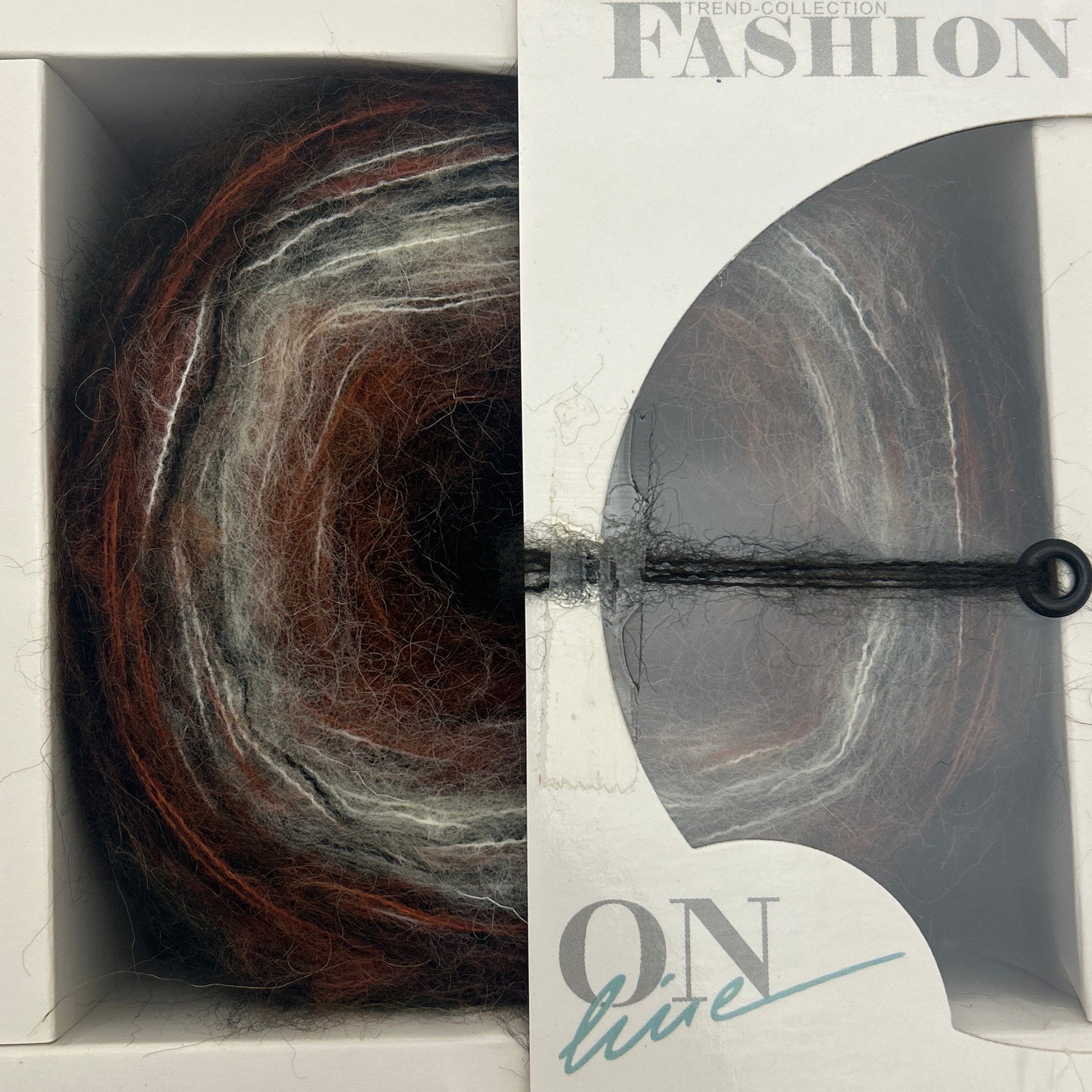 Yarn skein in a 'Fashion Box' packaging with a visible brand name.