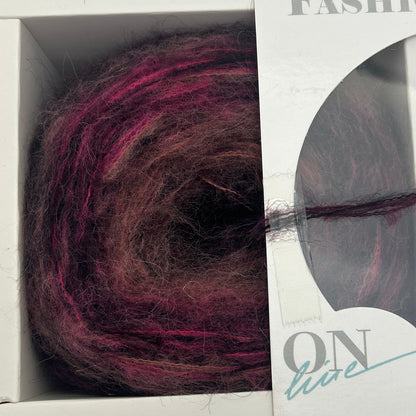 Ball of purple yarn in a packaging box with visible brand name.
