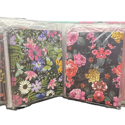 Floral and butterfly patterned notebooks in clear packaging