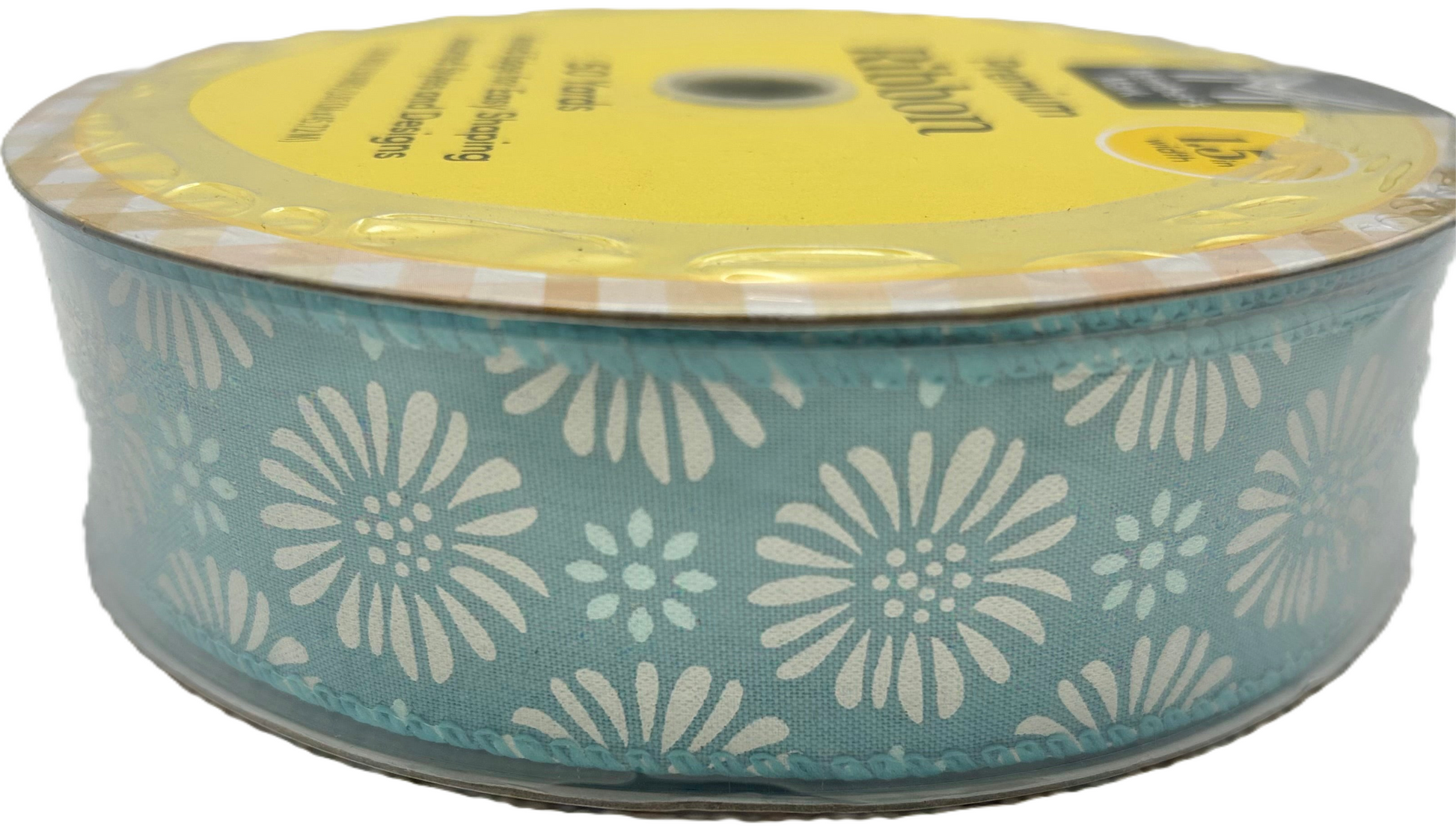 Spool of ribbon with floral pattern on a white background