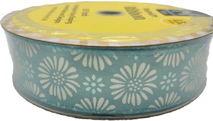 Spool of ribbon with floral pattern on a white background