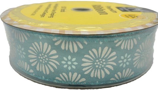 Spool of ribbon with floral pattern on a white background