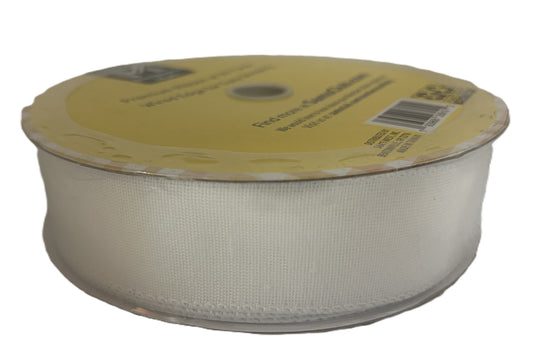 Spool of beige ribbon with a yellow label on a white background