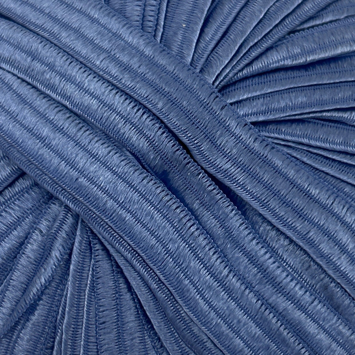 Close-up of pleated blue fabric texture