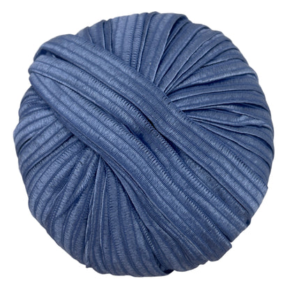Blue skein of yarn on a beige surface