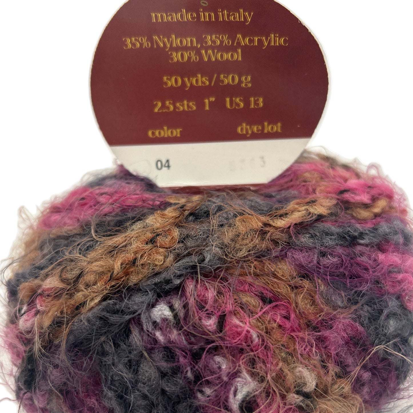 Multicolored yarn ball with a label indicating fiber content and measurements.