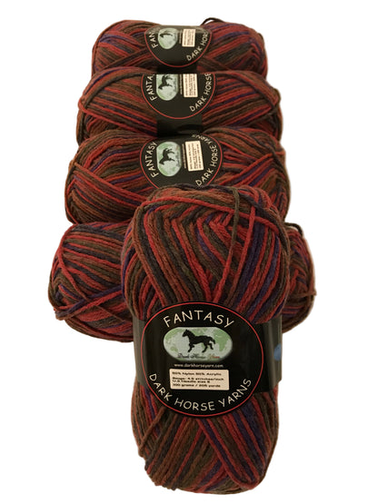 Four skeins of yarn with 'Fantasy' label on a beige background