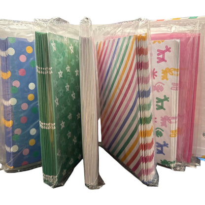 Stack of colorful paper packs on a black surface