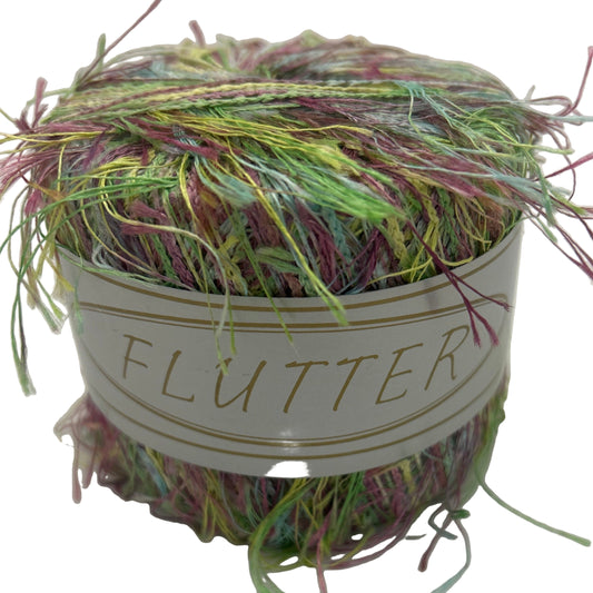 Multicolored yarn ball with 'Flutter' label on a white background