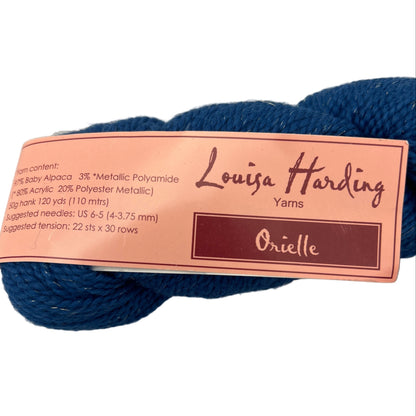 Navy yarn skein with Louisa Harding label on a white background