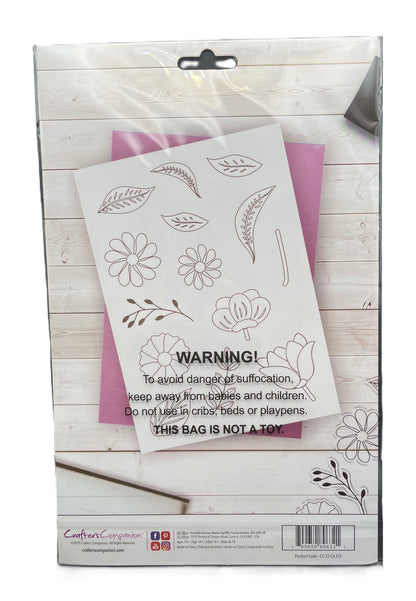 Floral design stencils in a packaging box on a wooden surface