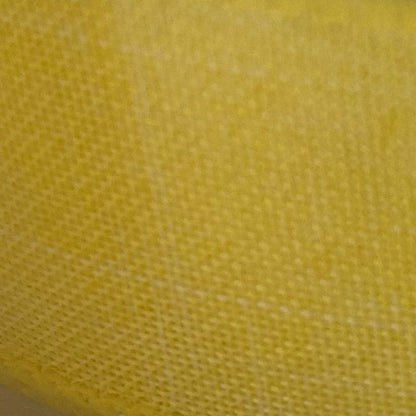 Close-up of yellow fabric with a textured pattern