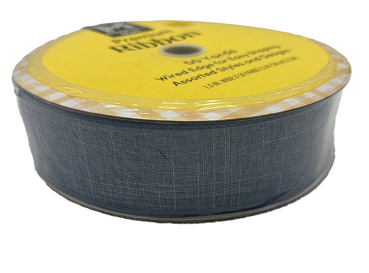 Spool of blue ribbon with yellow label on a white background