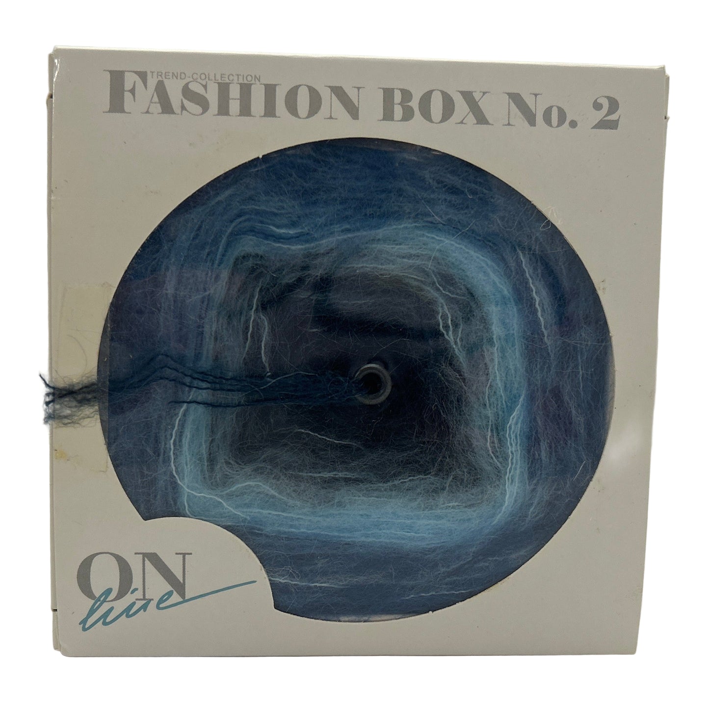 Box with blue yarn and 'ON live' branding on a white background