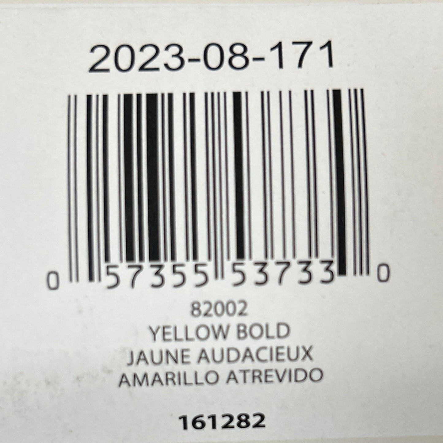 Product label with bar code and text on a textured surface