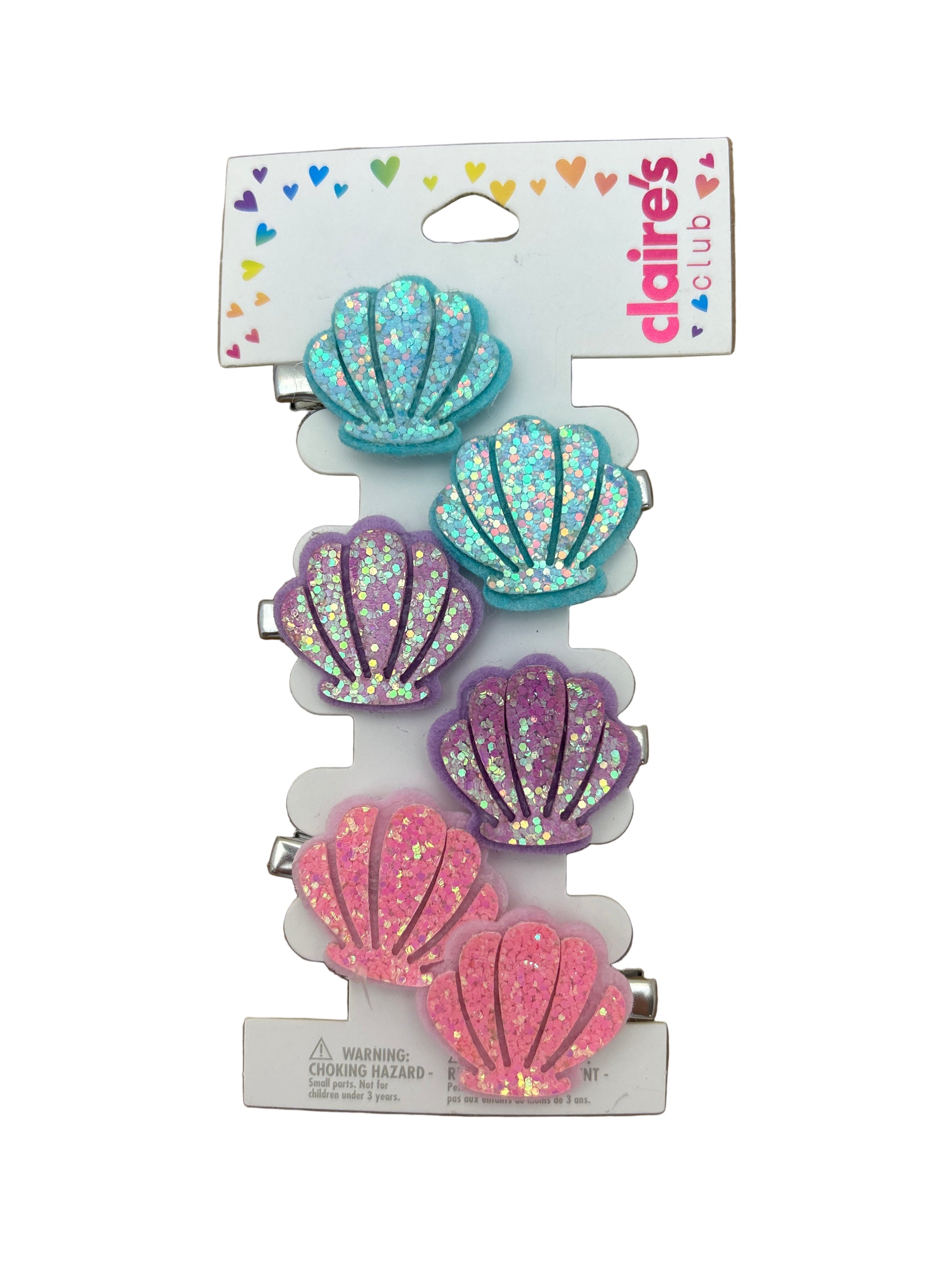 Set of five colorful shell-shaped hair clips on a Daisies branded card against a brown background