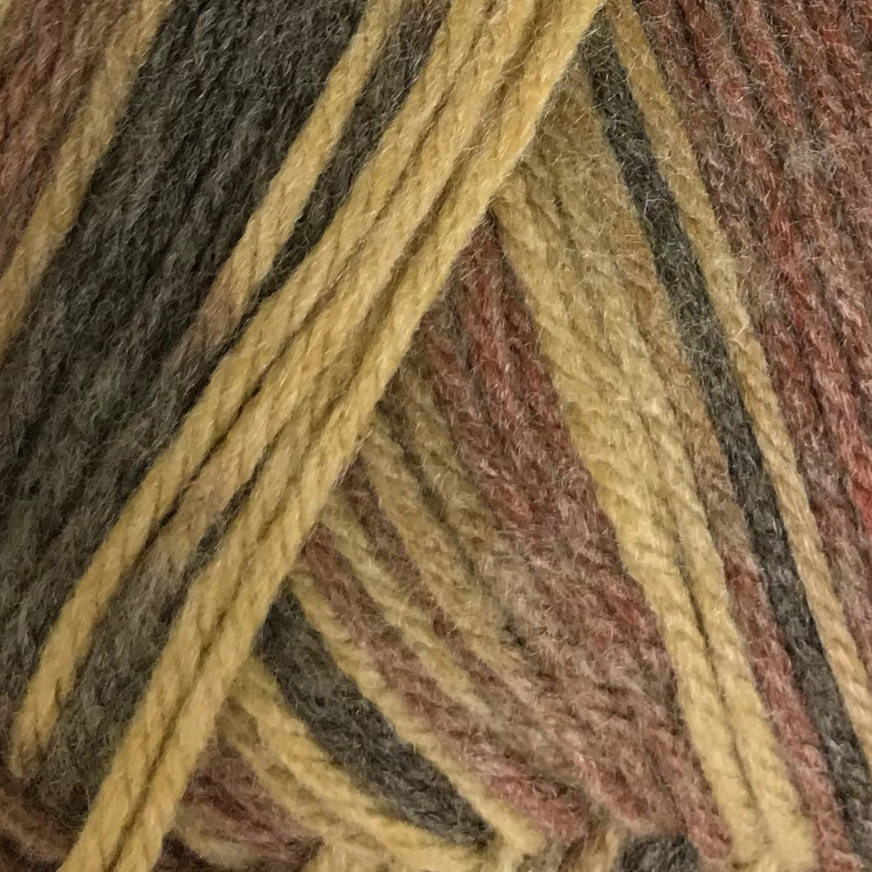 Close-up of multicolored yarn with brown, yellow, and red tones.
