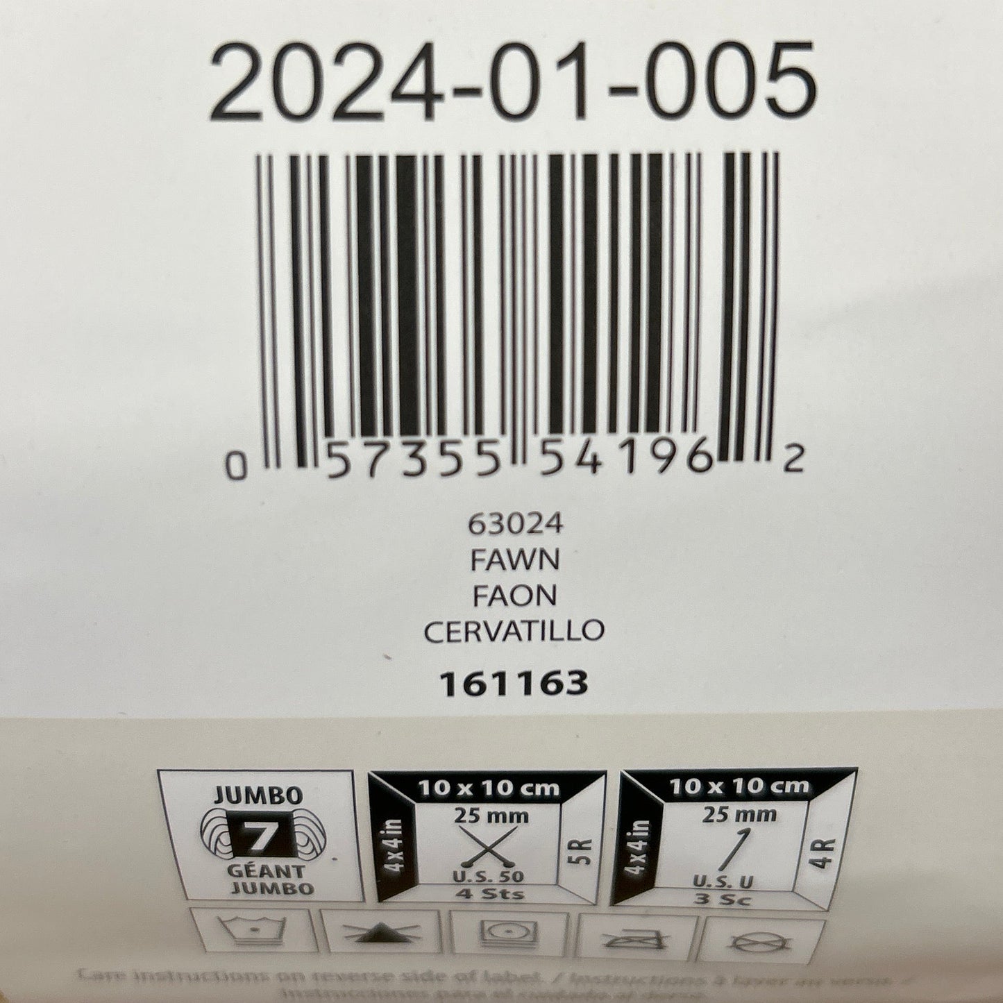 Close-up of a label on a woven product with text and barcodes.