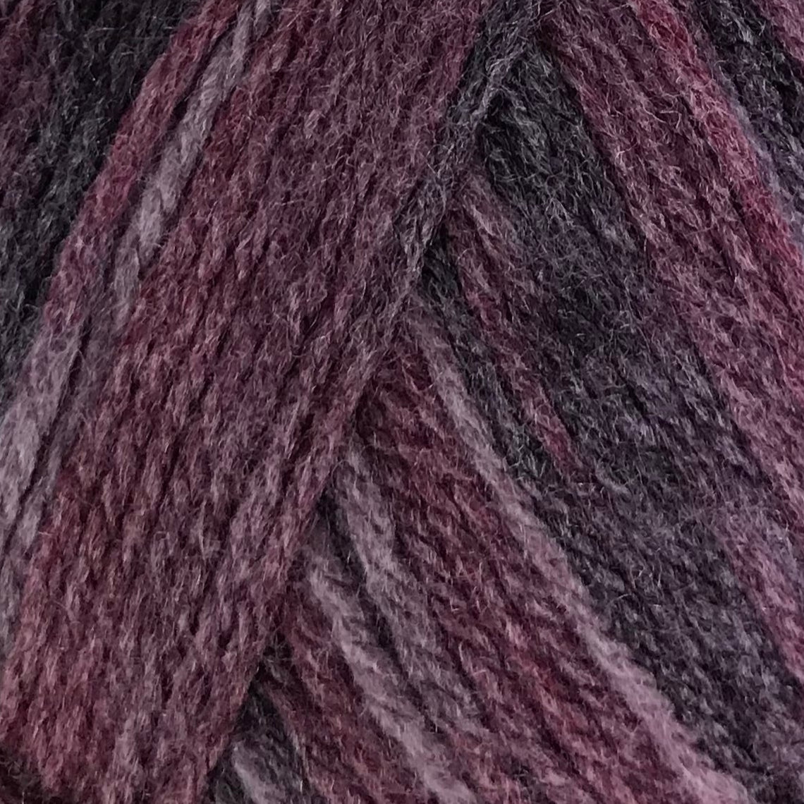 Ball of purple yarn with a label on a white background