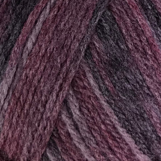Ball of purple yarn with a label on a white background