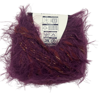 Purple yarn ball with a label on a white background