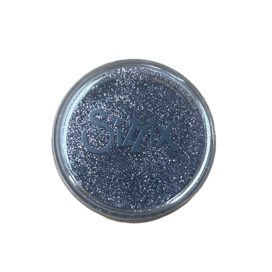 Silver glittery container lid on a beige background