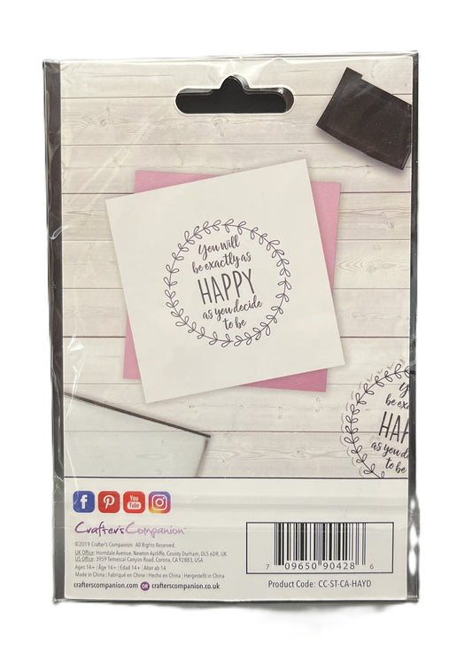Packaged product with a card and envelope on a wooden surface