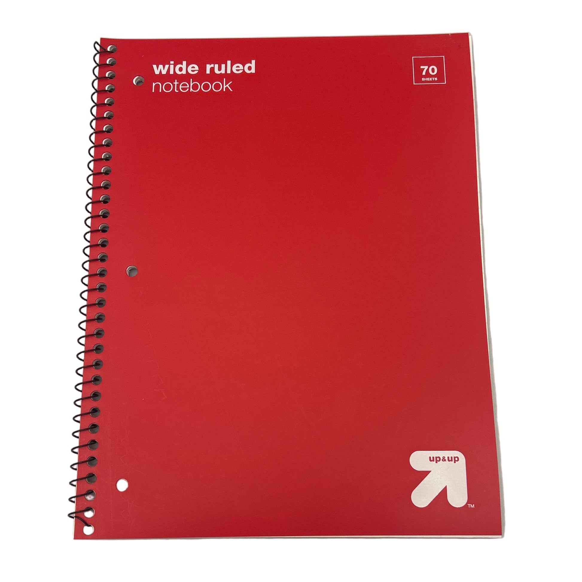 Red notebook with 'wide ruled' text and Up & Up logo on a white background
