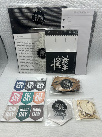 Collection of stationery items including notebooks, stickers, and a small figurine on a white surface.