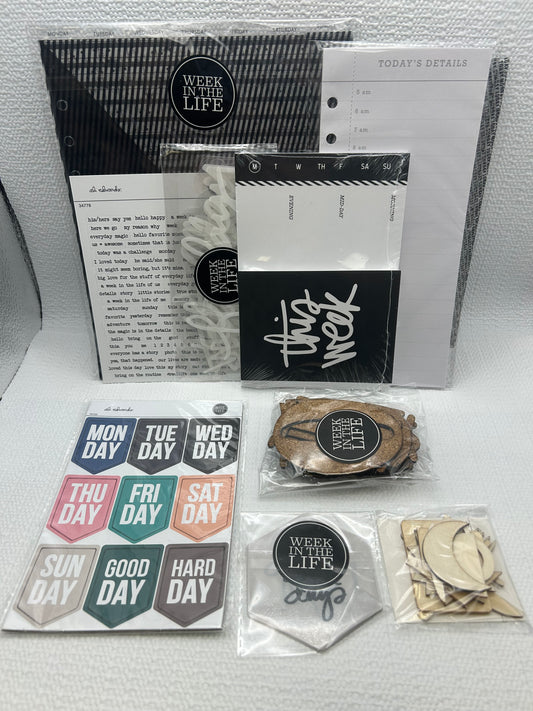 Collection of stationery items including notebooks, stickers, and a small figurine on a white surface.