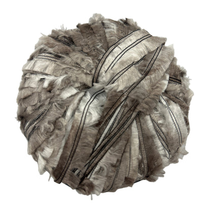 Decorative item resembling a pomander made of ribbons on a white background