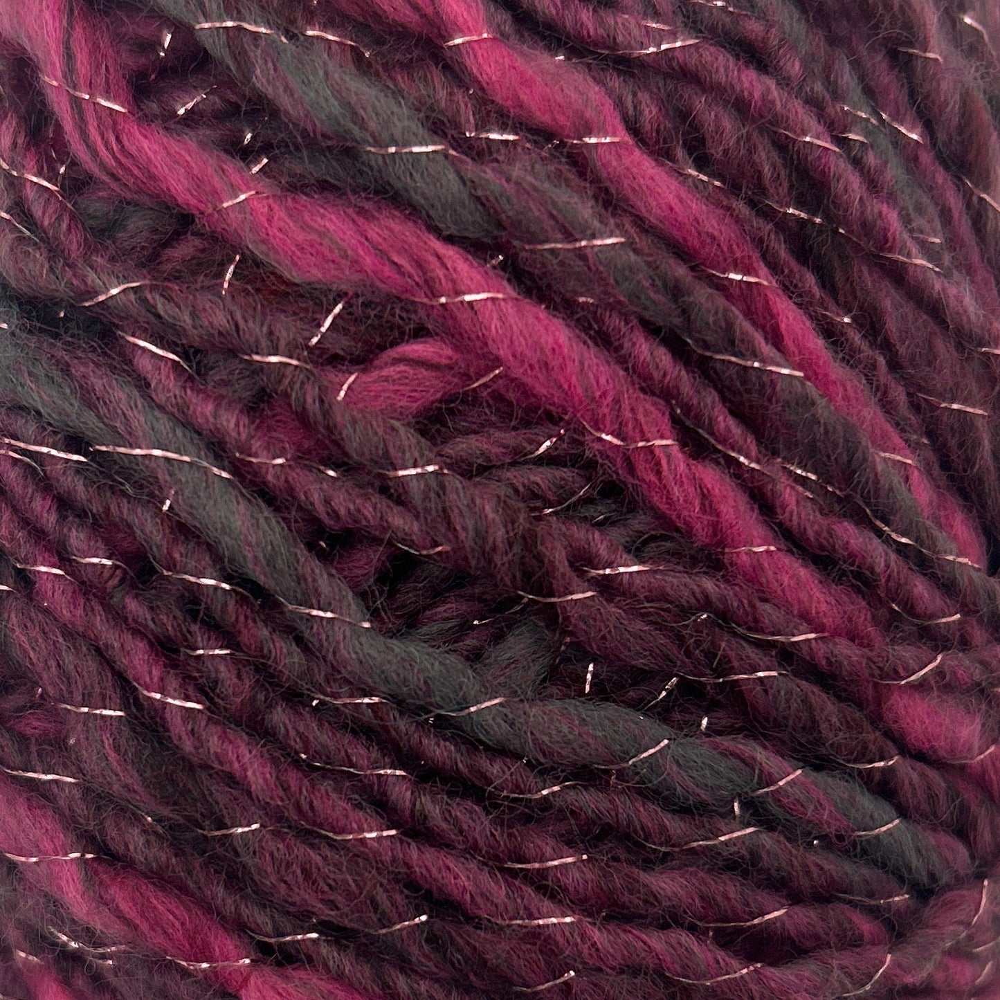 Ball of purple and black yarn on a white background