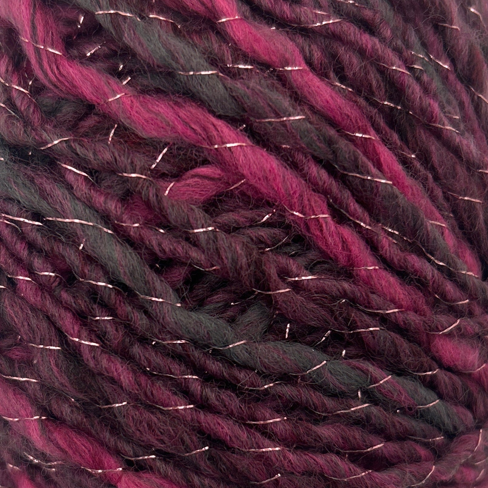 Ball of purple and black yarn on a white background