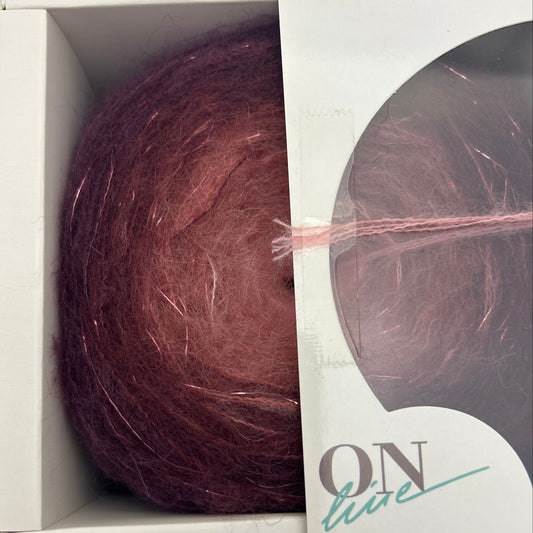 Ball of yarn in a box with 'Fashion' branding on a gray background